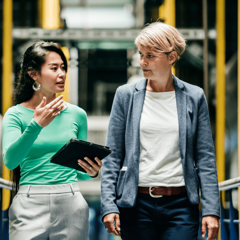 Two women discussing while walking.